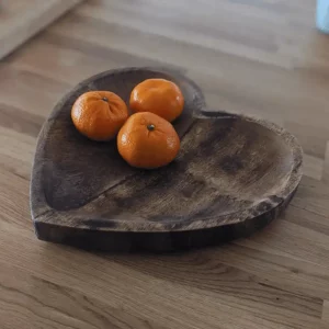 Large mango wood heart-shaped plate on wooden surface