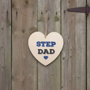Wooden heart-shaped hanging sign with text “Step Dad” in blue and black letters and a small heart icon, hanging by a jute rope