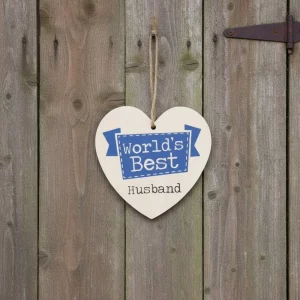 Wooden heart-shaped hanging sign with text “World’s Best Husband” in blue and black lettering, hanging by a jute rope on a plain white background.