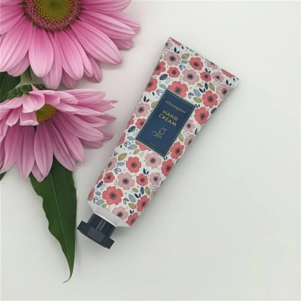 Strawberry hand cream with pink floral design tube.