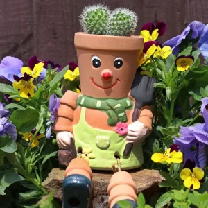 Outdoor planter styled among flowers in a garden