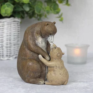 Rustic bear ornament displayed on table with candle in background