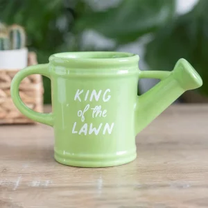 King of the Lawn green watering can mug on wooden table