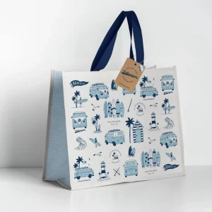 Reusable camper van shopping bag with blue and white beach design and sturdy navy handles.