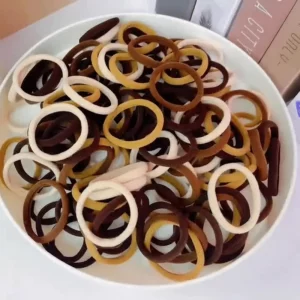 Bowl filled with mixed brown and beige soft hair ties.