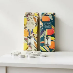 Orange Blossom and Lemon Verbena scented tea lights side by side in colourful packaging