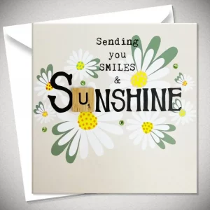 Greeting card with daisy design and scrabble tile spelling “Smiles & Sunshine”