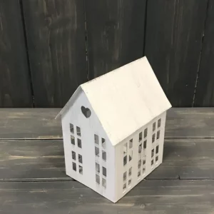 Rustic white metal house-shaped tealight holder with cut-out windows and heart detail.