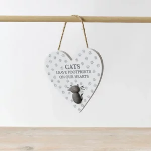 White heart-shaped hanging plaque with pebble cat design and text “Cats leave footprints on our hearts.”