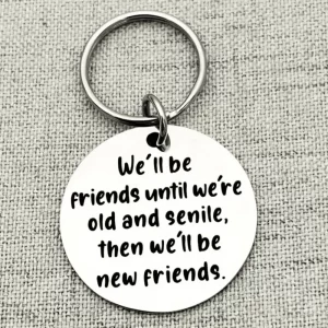 Funny friendship keyring engraved with the quote “We’ll be friends until we’re old and senile, then we’ll be new friends.”