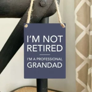 Mini metal sign saying I’m not retired I’m a professional Grandad