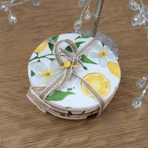 Round wooden coaster set with lemon botanical design tied with jute string