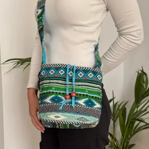 Blue and green woven sling bag with adjustable shoulder strap