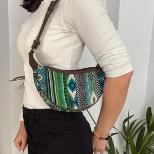 Green woven hobo shoulder bag worn on the shoulder showing size and fit