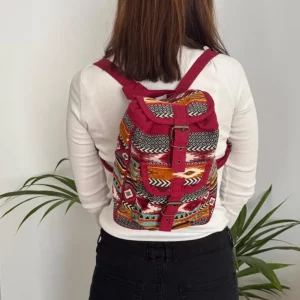Maroon woven backpack worn on the back showing size and fit