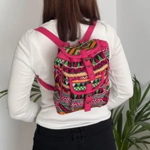 Pink woven backpack worn on the back showing size and fit