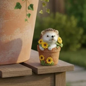 Hedgehog ornament in flower pot with yellow sunflowers
