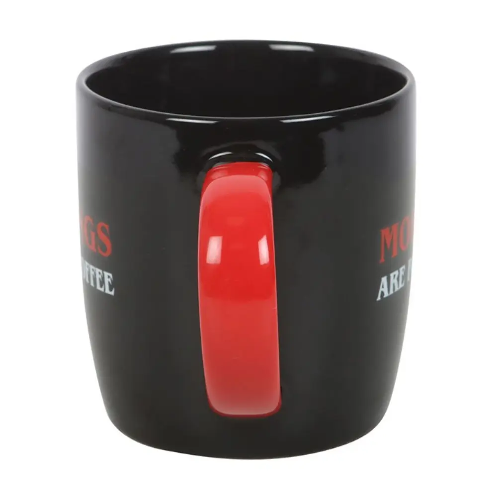 Side view of black coffee mug with bold red handle