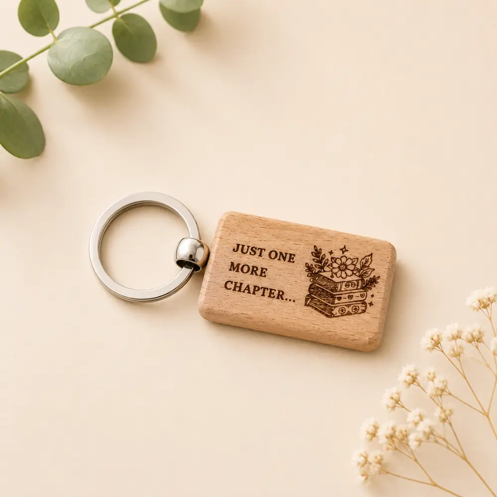 Laser engraved wooden book lover keyring with the words "Just One More Chapter..." on natural varnished wood.
